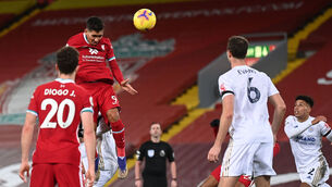 <p>Roberto Firmino scores Liverpool's third goal at Anfield. Photo: Laurence Griffiths/PA</p>
