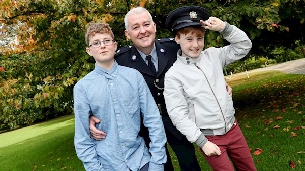 Garda Pauric Deery, Co. Sligo, who received a Certificate at The National Bravery Award at Farmleigh with his sons Cathal, 13, and Cillian, 11.