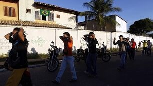 Protestors clash with police outside football match in Brazil