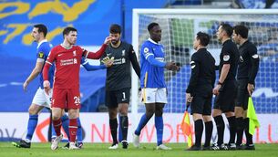 <p>POINTED REMARKS: Liverpool’s Andrew Robertson talks to referee Stuart Attwell as Brighton’s Danny Welbeck shakes his hand after the Premier League match at the Amex Stadium on Saturday.</p>