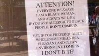 Notice on café owner's window says 'If you are allergic to black people, don't come in'
