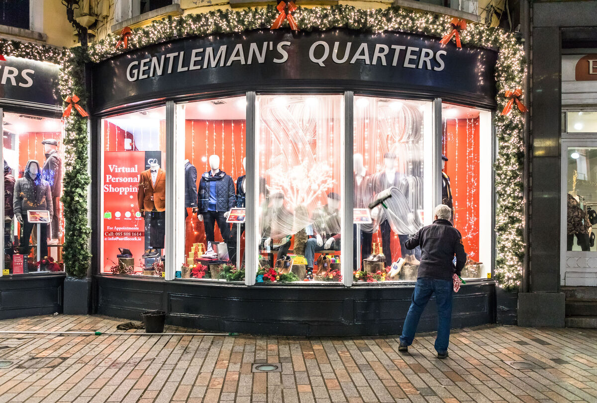 Rory O’Donovan from Kileens cleans the windows of men’s shop Gentleman’s Quarters on Patrick’s Street, Cork in preparation for the reopening of shops when the country exits a six week Level 5 lockdown. 	Picture; David Creedon/Anzenberger