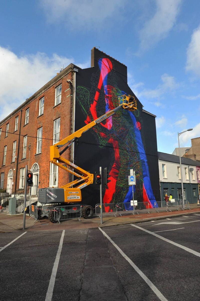 A gable wall mural of a hurler in action, at South Terrace/Anglesea Street, Cork. Picture: Larry Cummins