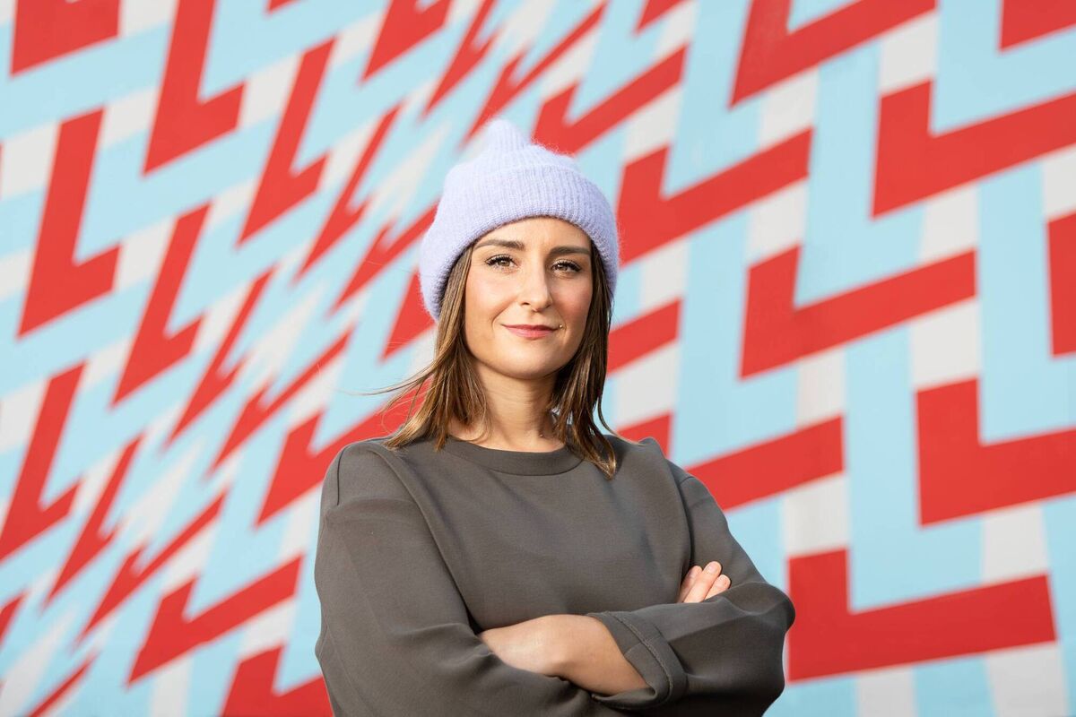 Ardú artist Deirdre Breen standing in front of her mural at Wandesford Quay