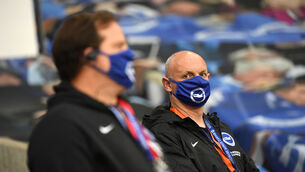 <p>Staff at Brighton wear face coverings at a match against Manchester United. Picture: Andy Rain/NMC Pool/PA</p>