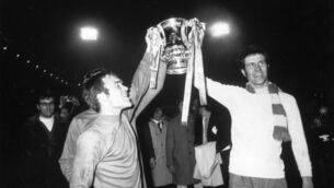 <p>Chelsea players Peter Osgood (right) and Ron Harris lift the FA Cup trophy in celebration after beating Leeds United 2-1 after extra time in the FA Cup Final replay at Old Trafford in 1970. Picture: Getty Images</p>
