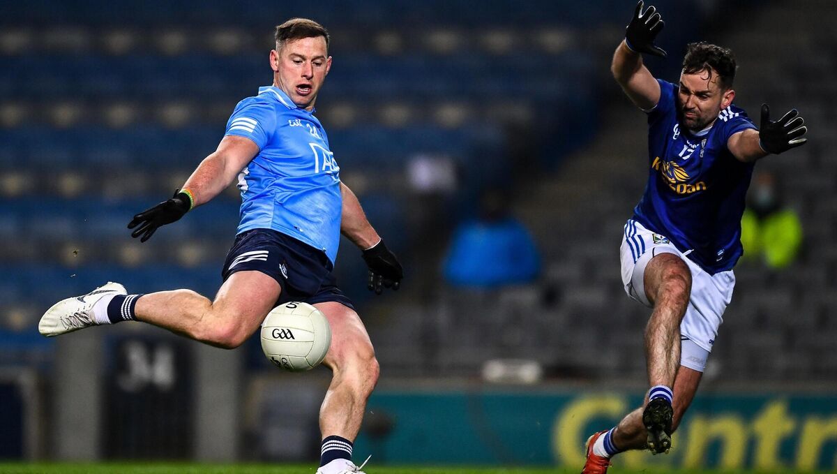 Philip McMahon of Dublin has a shot on goal despite the efforts of Niall Murray of Cavan. Picture: Ray McManus/Sportsfile