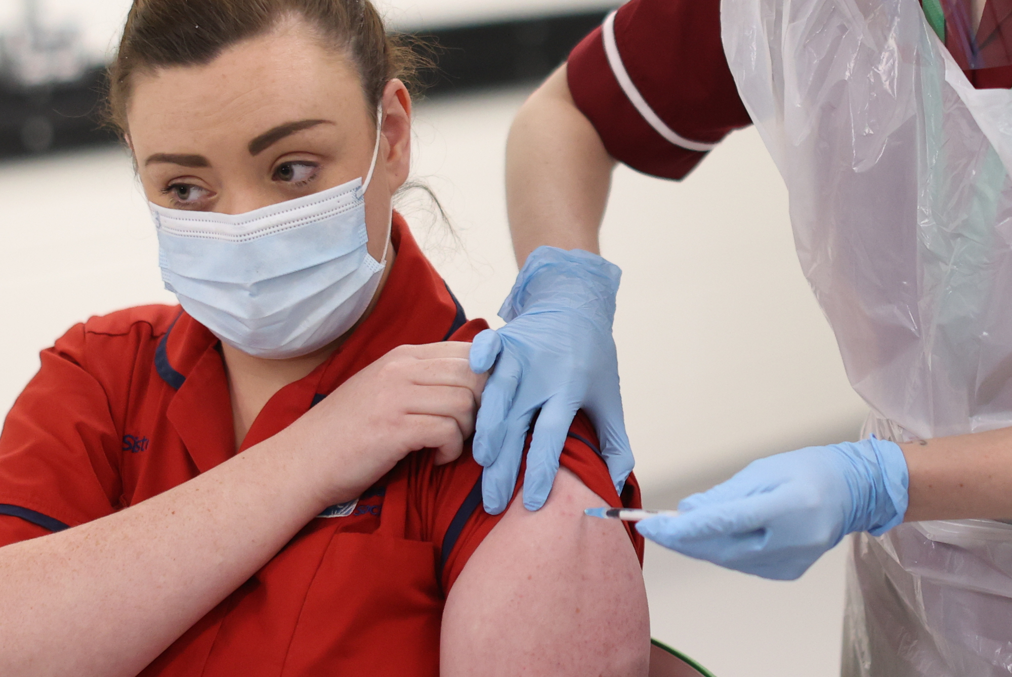 Sister Joanna Sloan (left) becomes the first person in Northern Ireland to receive the first of two Pfizer/BioNTech Covid-19 vaccine jabs, at the Royal Victoria Hospital, in Belfast. Picture: Liam McBurney/PA Wire