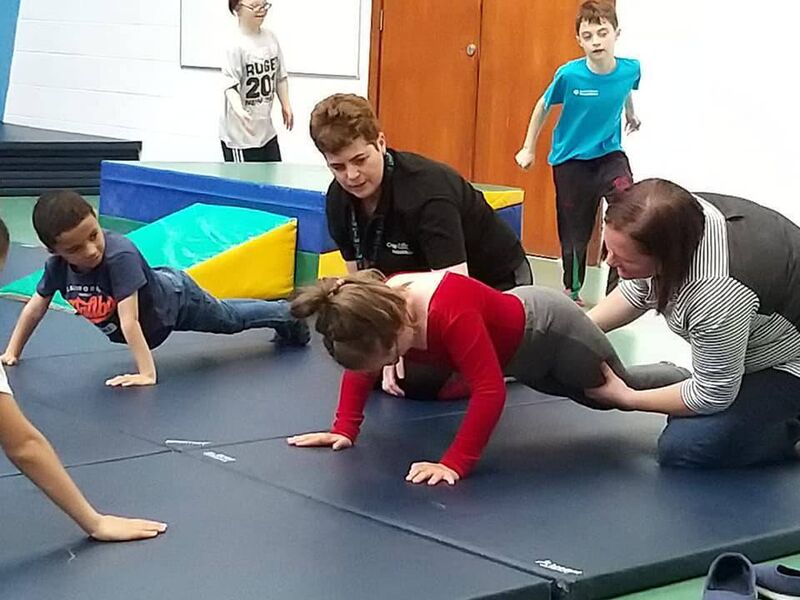 Scarlett Beecher working her press-ups with help from mum Susan, as coach Clare Sheehan encourages.