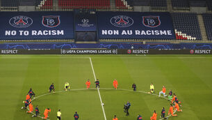 <p>Paris St Germain and Istanbul Basaksehir kneel to show support for the fight against racism (Xavier Laine/AP)</p>