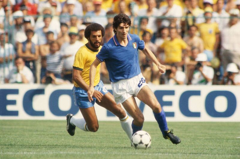 BARCELONA, SPAIN - JULY 5: Paolo Rossi of Italy shields the ball from Junior of Brazil during the World Cup Round Two, Group Three match between Brazil and Italy held at the Sarria Stadium, Barcelona, Spain on July 5, 1982. Italy won the match 3-2. (Photo by Getty Images) BARCELONA, SPAIN - JULY 5: Paolo Rossi of Italy shields the ball from Junior of Brazil during the World Cup Round Two, Group Three match between Brazil and Italy held at the Sarria Stadium, Barcelona, Spain on July 5, 1982. Italy won the match 3-2. (Photo by Getty Images)