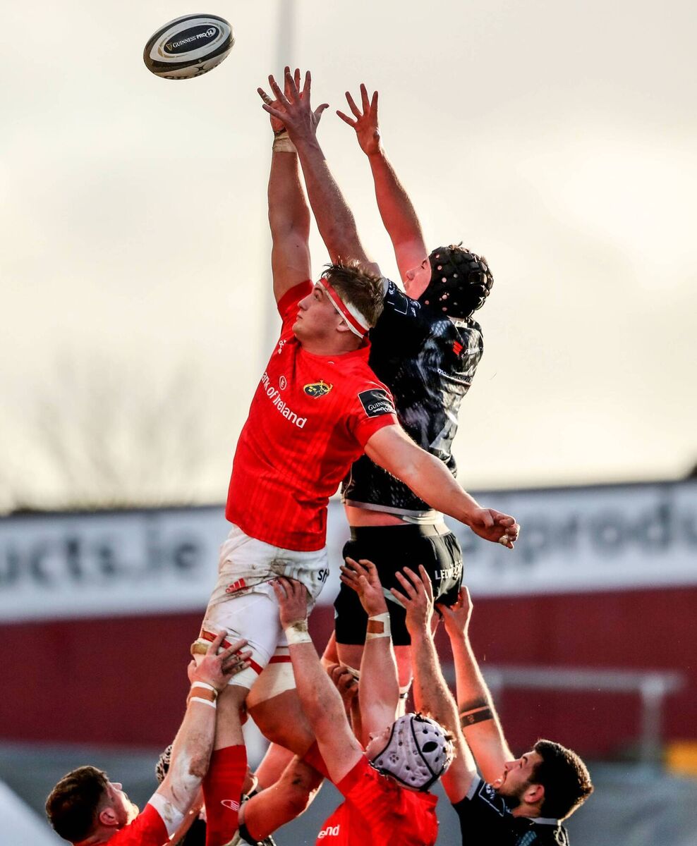 Munster's Gavin Coombes and Adam Beard of Ospreys compete in a line out 