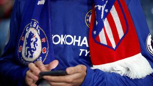 <p>A Chelsea fan with a half-and-half Chelsea-Atletico Madrid scarf. Picture: PA</p>