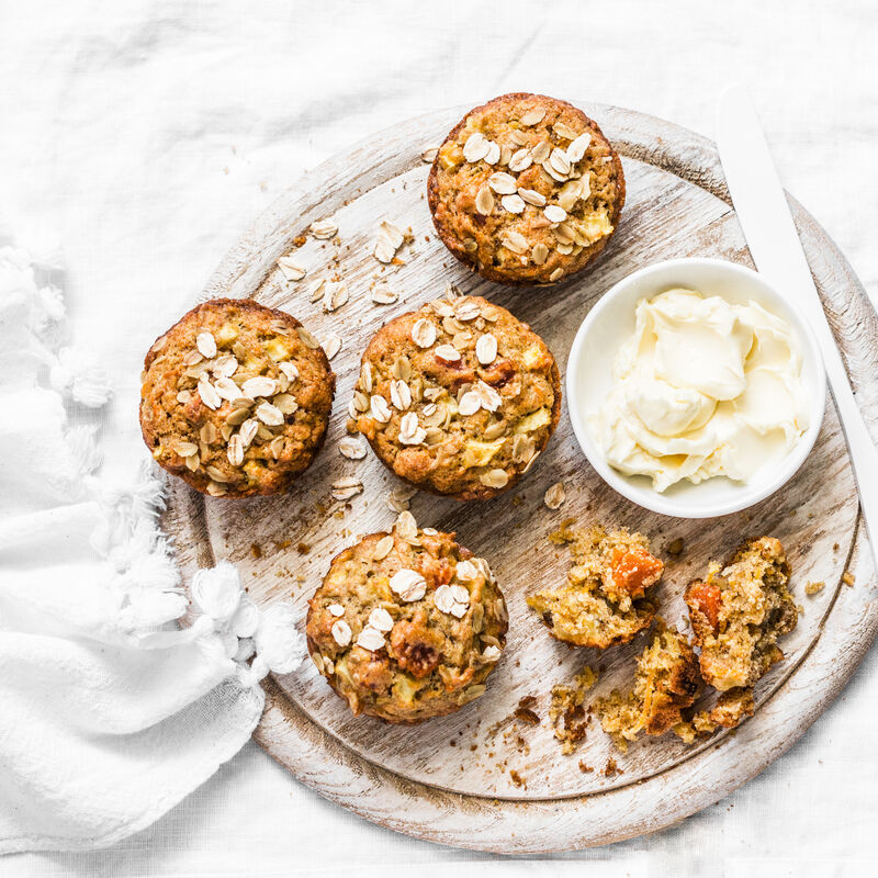 Pumpkin oatmeal gluten free muffins on rustic chopping board on light background. Pumpkin oatmeal gluten free muffins on rustic chopping board on light background.