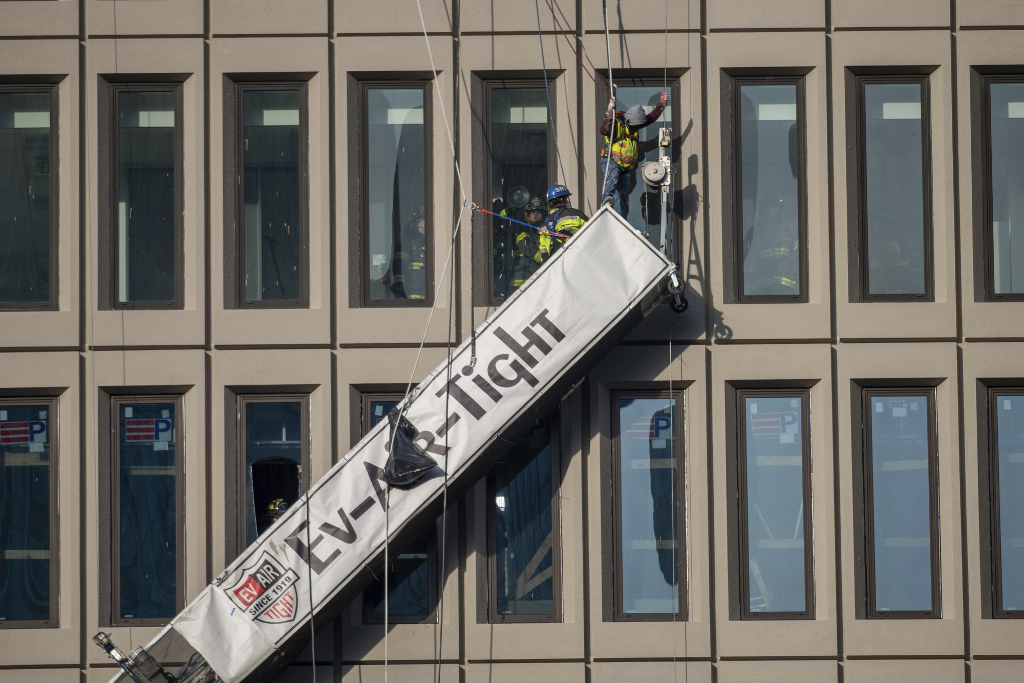 Window cleaners left dangling after explosion in high-rise building