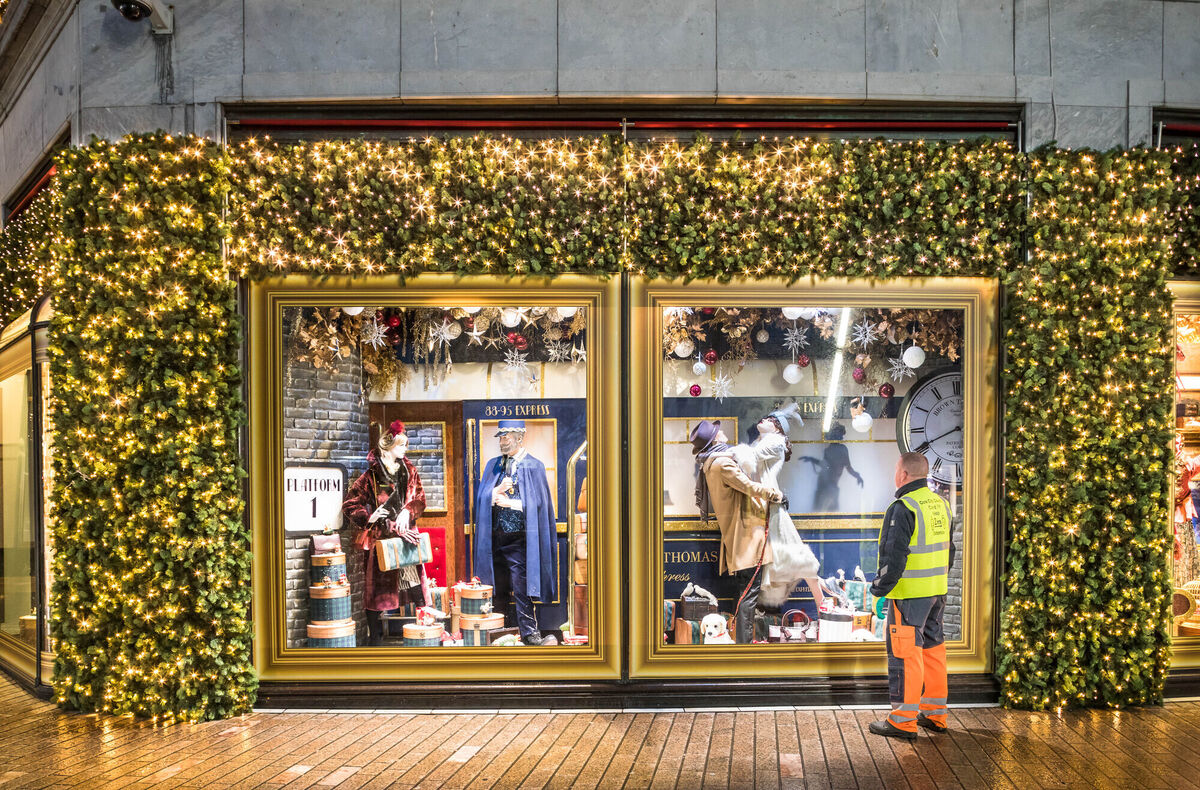 A Cork City Council worker looks at the Christmas window on a theme at Brown Thomas on Patrick's Street, Cork. Picture: David Creedon / Anzenberger