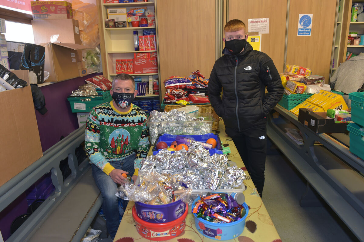  Volunteers Damien Morley and Dylan McCarthy getting the donations ready for the Christmas day delivery to service users of Penny Dinners, Cork. Picture Dan Linehan