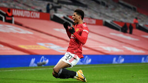 <p>MAN OF THE MOMENT: Manchester United striker Marcus Rashford celebrates scoring the winner during the Premier League clash with Wolves last night at Old Trafford.	 Picture: Michael Regan/PA </p>