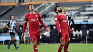 <p>Liverpool's Roberto Firmino and Mohamed Salah react after a missed chance at St James' Park. Picture: Peter Powell/PA</p>