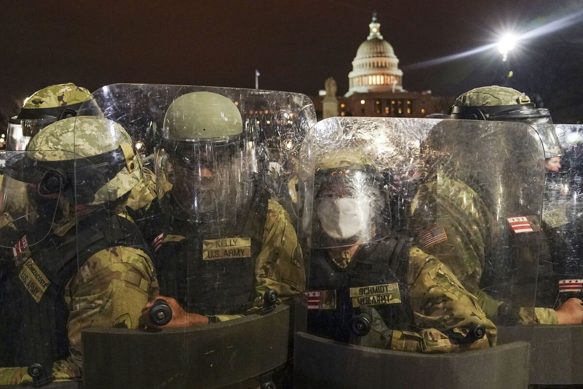 DC National Guard stand outside the Capitol, Wednesday night, Jan. 6, 2021, after a day of rioting protesters. It's been a stunning day as a number of lawmakers and then the mob of protesters tried to overturn America's presidential election, undercut the nation's democracy and keep Democrat Joe Biden from replacing Trump in the White House. Picture: AP Photo/John Minchillo