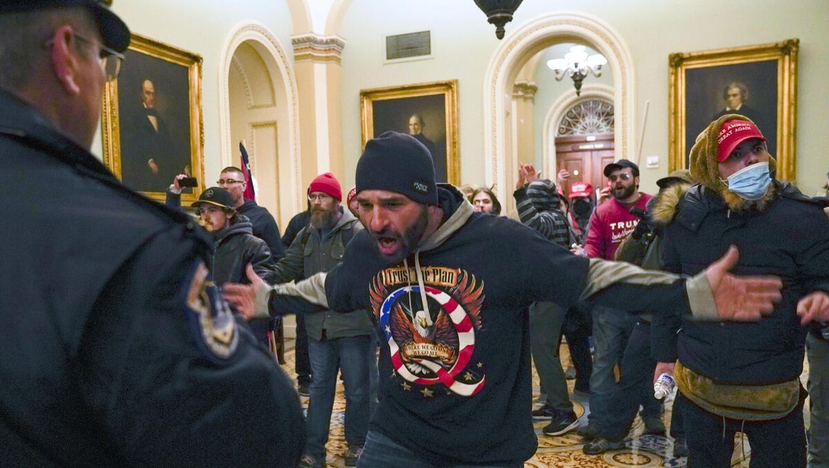 Trump supporters gesture to U.S. Capitol Police in the hallway outside of the Senate chamber at the Capitol in Washington. Picture: AP Photo/Manuel Balce Ceneta, File Trump supporters gesture to U.S. Capitol Police in the hallway outside of the Senate chamber at the Capitol in Washington. Picture: AP Photo/Manuel Balce Ceneta, File