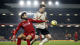 <p>Liverpool's Mohamed Salah battles with Manchester United's Harry Maguire at Anfield last January. Photo: Martin Rickett/PA</p>