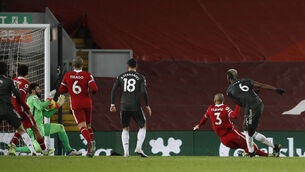 <p>Manchester United's Paul Pogba (right) sees his shot saved by Liverpool goalkeeper Alisson. Picture: Phil Noble</p>