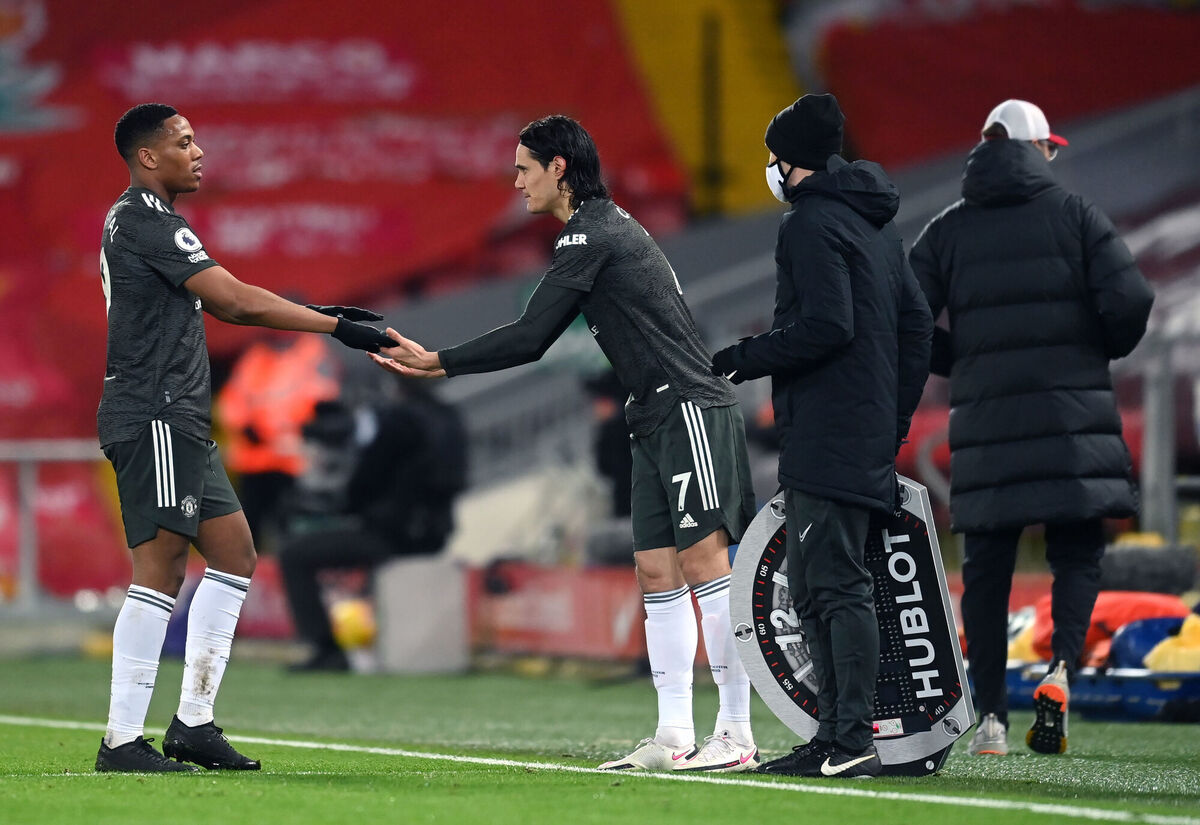 Manchester United's Anthony Martial greets Edinson Cavani as he leaves the field of play. Picture: Michael Regan