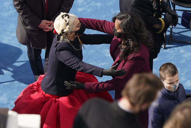 Lady Gaga and former first lady Michelle Obama meet at the 59th Presidential Inauguration. Picture: AP Photo/Susan Walsh, Pool Lady Gaga and former first lady Michelle Obama meet at the 59th Presidential Inauguration. Picture: AP Photo/Susan Walsh, Pool