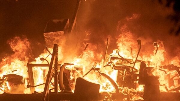 Office chairs burn after police try to storm the Hong Kong Polytechnic University in Hong Kong today. Office chairs burn after police try to storm the Hong Kong Polytechnic University in Hong Kong today.
