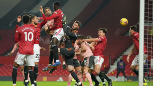 <p>Sheffield United’s Kean Bryan rises highest to head past Manchester United goalkeeper David de Gea for the opening goal in last night’s Premier League clash at Old Trafford. Picture: Dave Thompson</p>