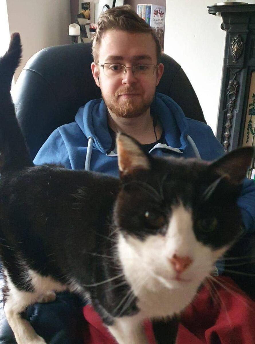 Gavin Connolly with his cat, Felix. Ms Mac Namara says Felix sits beside Gavin every day.