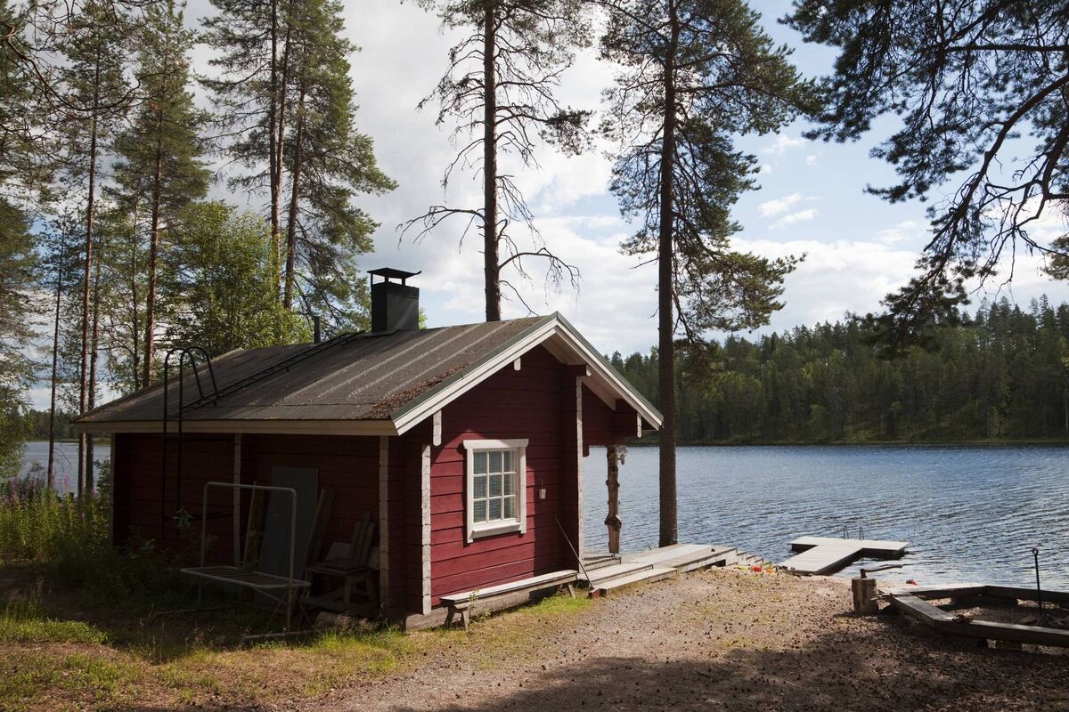 A typical sauna hut at an outdoor activity area by a lake in Finland, with a jetty and picnic area. The sauna is an integral part of Finnish culture - there are 3 million saunas in Finland, an average of one per household, and the sauna seen as a necessity and an important part of the national identity.