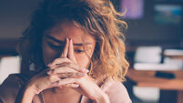 Tired Young Woman Leaning Head on Hands