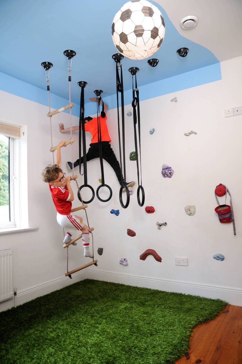 A fun children’s room featuring a climbing wall and play area, by Anna Finnegan Design.
