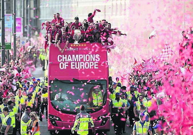 Liverpool's players with the UEFA Champions League trophy on board a parade bus after winning the UEFA Champions League in 2019. Picture: Nigel Roddis/Getty Images