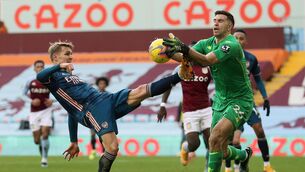 <p>STEADY HANDS: Arsenal's Martin Odegaard (left) and Aston Villa goalkeeper Emiliano Martinez battle for the ball during Villa's 1-0 on Saturday. Picture: Catherine Ivill</p>