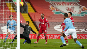 <p> Raheem Sterling on his way to scoring Manchester City's third goal as Liverpool goalkeeper Alisson looks on at Anfield. Picture: Jon Super/PA</p>