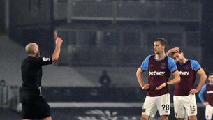 <p>Match referee Mike Dean shows West Ham United's Tomas Soucek a red card for violent conduct during the Premier League match at Craven Cottage, London. Picture date: Saturday February 6, 2021.</p>