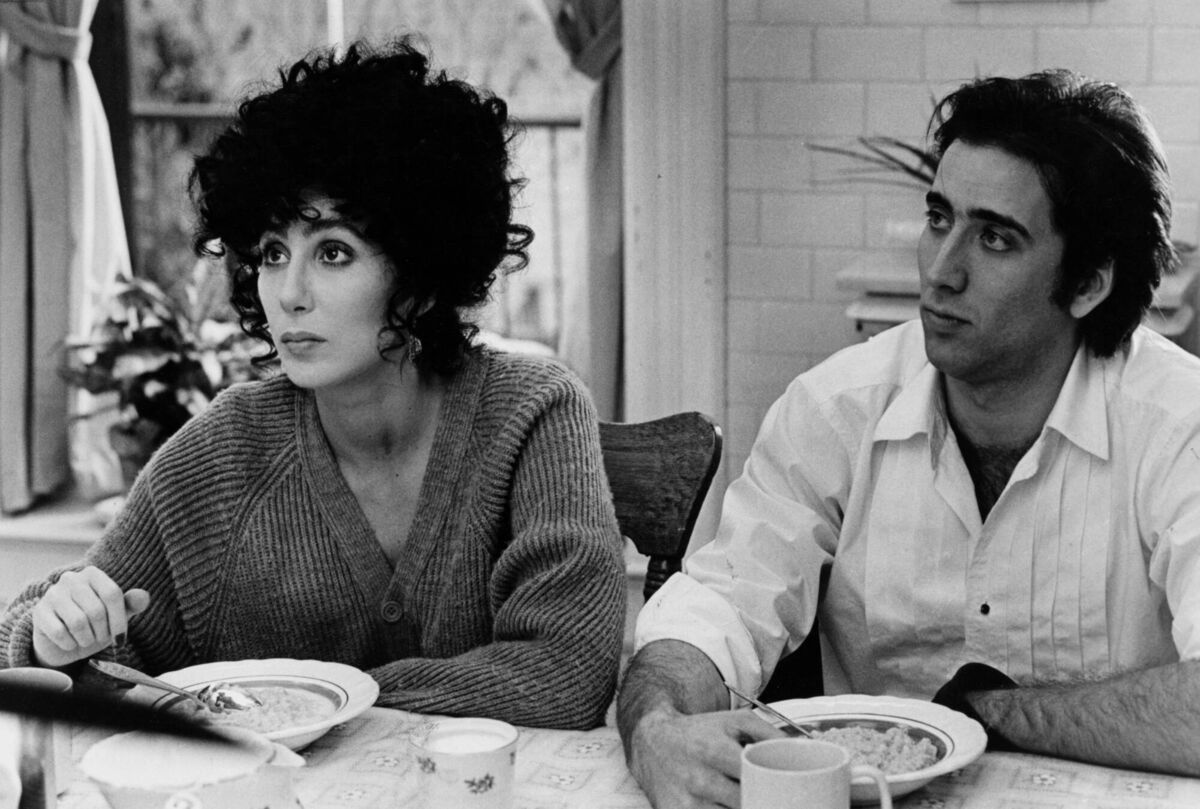 Cher and Nicolas Cage in Moonstruck, a sophisticated romantic comedy. Cher and Nicolas Cage in Moonstruck, a sophisticated romantic comedy.