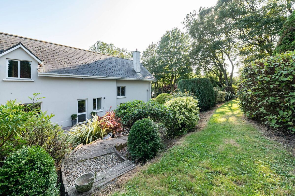 Rear settles into landscaped grounds of 1.3 acres