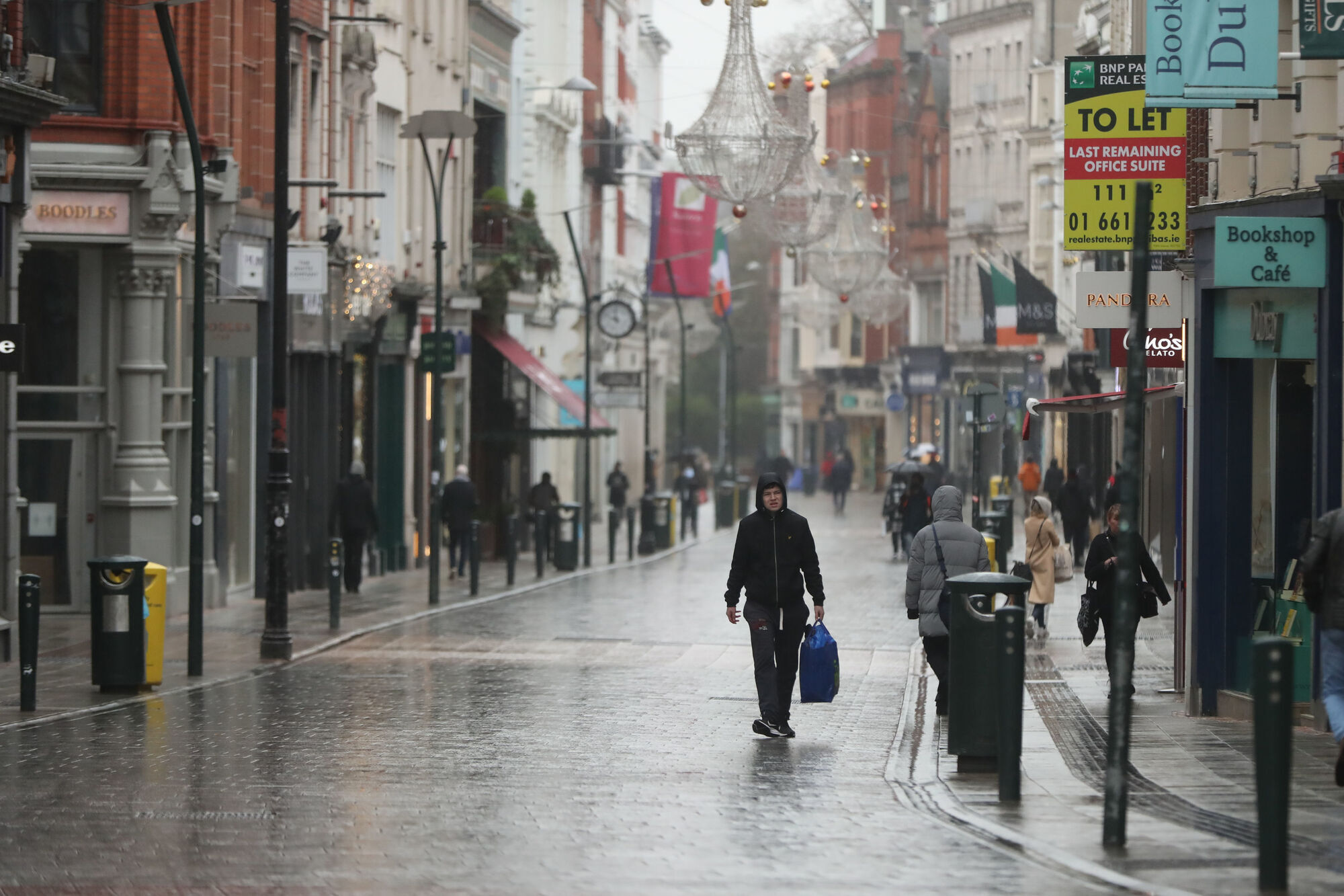 People walk along a near empty Grafton Street in Dublin. The extended lockdown will mean that unemployment will not return to its pre-pandemic level of below 5% 'until at least 2023. Picture: Niall Carson/PA