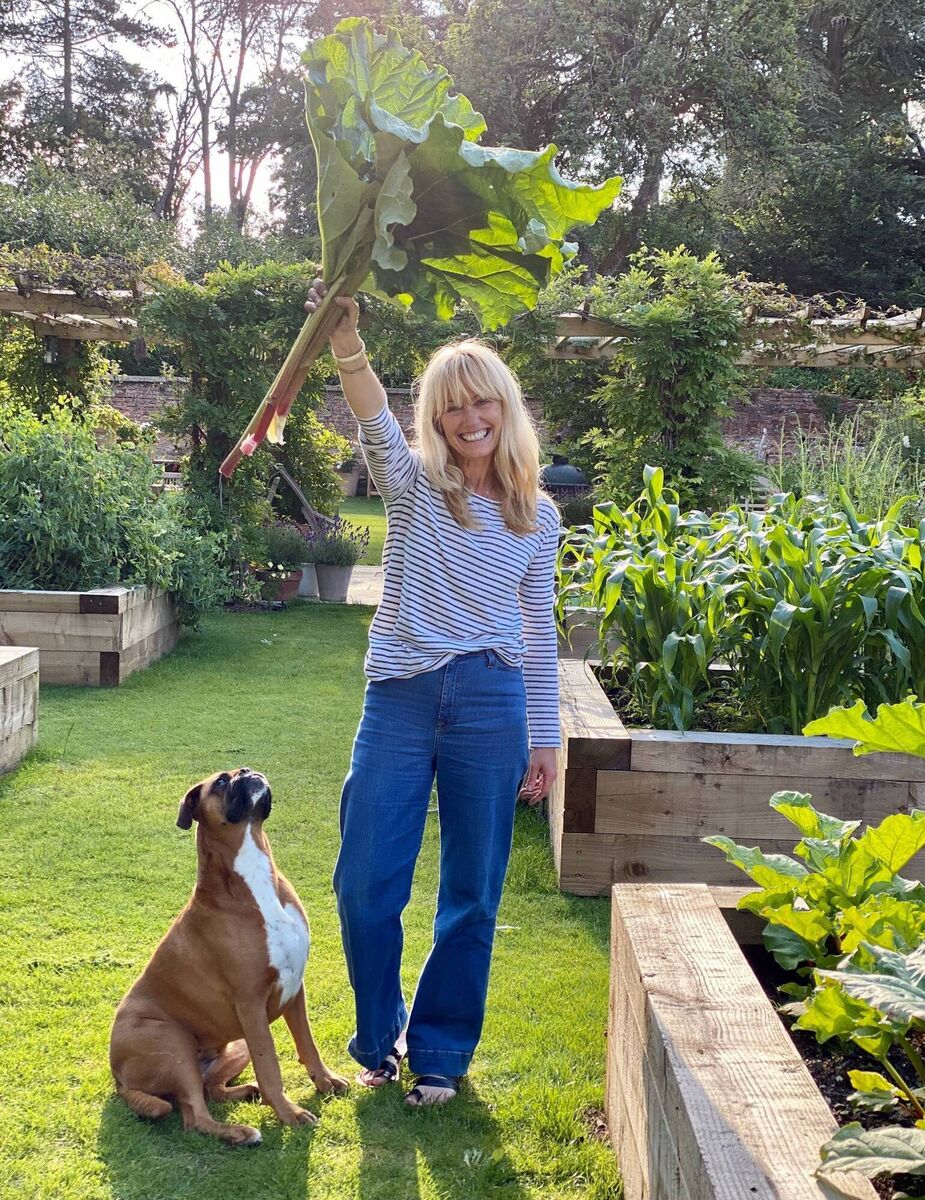 Chef, cookbook author and TV personality Clodagh McKenna and her dog Nolly in the restored walled garden of her Hampshire home.