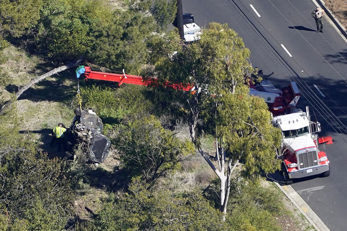 A crane is used to lift a vehicle following a rollover accident involving golfer Tiger Woods, last week. Picture: Mark J Terrill