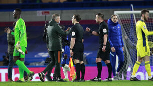 <p>Manchester United manager Ole Gunnar Solskjaer, left, fistbumps referee Stuart Attwell, right, after the match (Ian Walton/PA)</p>