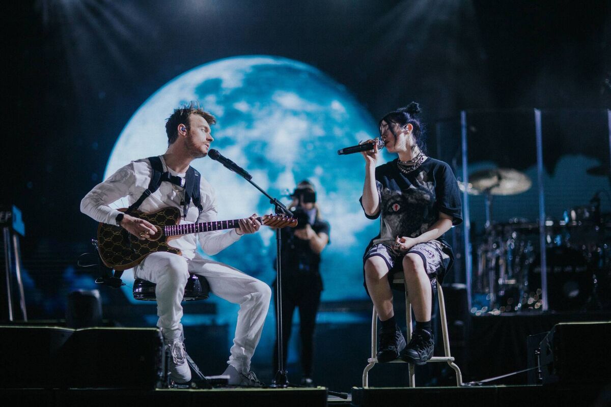 Billie Eilish and her brother Finneas O’Connell on stage in Billie Eilish: The World’s A Little Blurry. Billie Eilish and her brother Finneas O’Connell on stage in Billie Eilish: The World’s A Little Blurry.