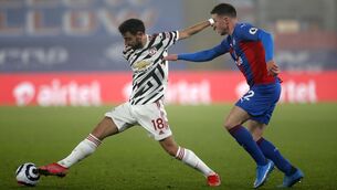 <p>Manchester United's Bruno Fernandes and Crystal Palace's James McCarthy (right) battle for the ball during the Premier League match at Selhurst Park</p>