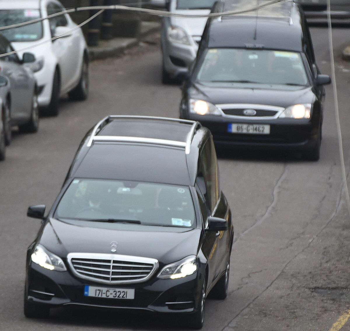  Two hearses and the funeral cortege leave from the church after requiem mass for brothers Paddy and Willie Hennessy. Photo: Larry Cummins
