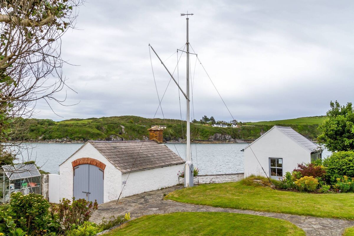 Rocket House is at the water's edge, by a boathouse in Castletownshend