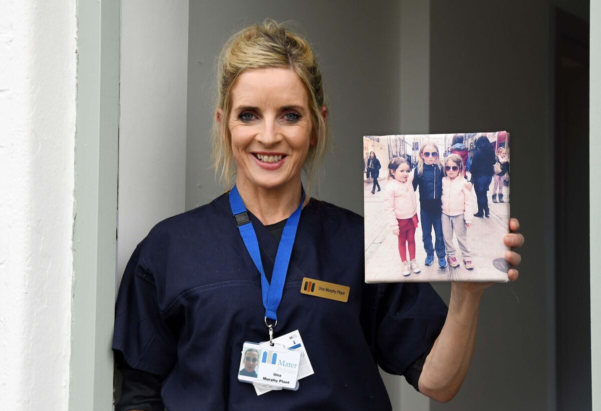 Una Murphy Plant, cardiac nurse at Mater Private Hospital, Cork, with a photograph of her daughters Kokie, Letti and Rosie. Picture: Denis Minihane